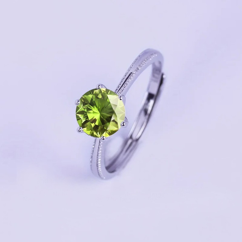 Anillo de compromiso en plata detalle de borde efecto perlado con peridoto